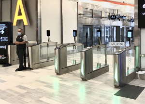 a man stands next to egates at the tampa airport